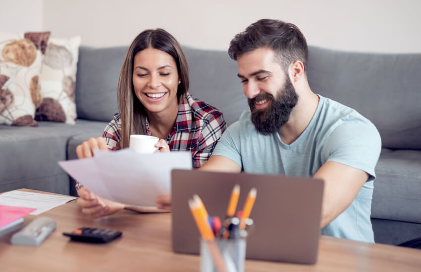 a couple looking at papers happily