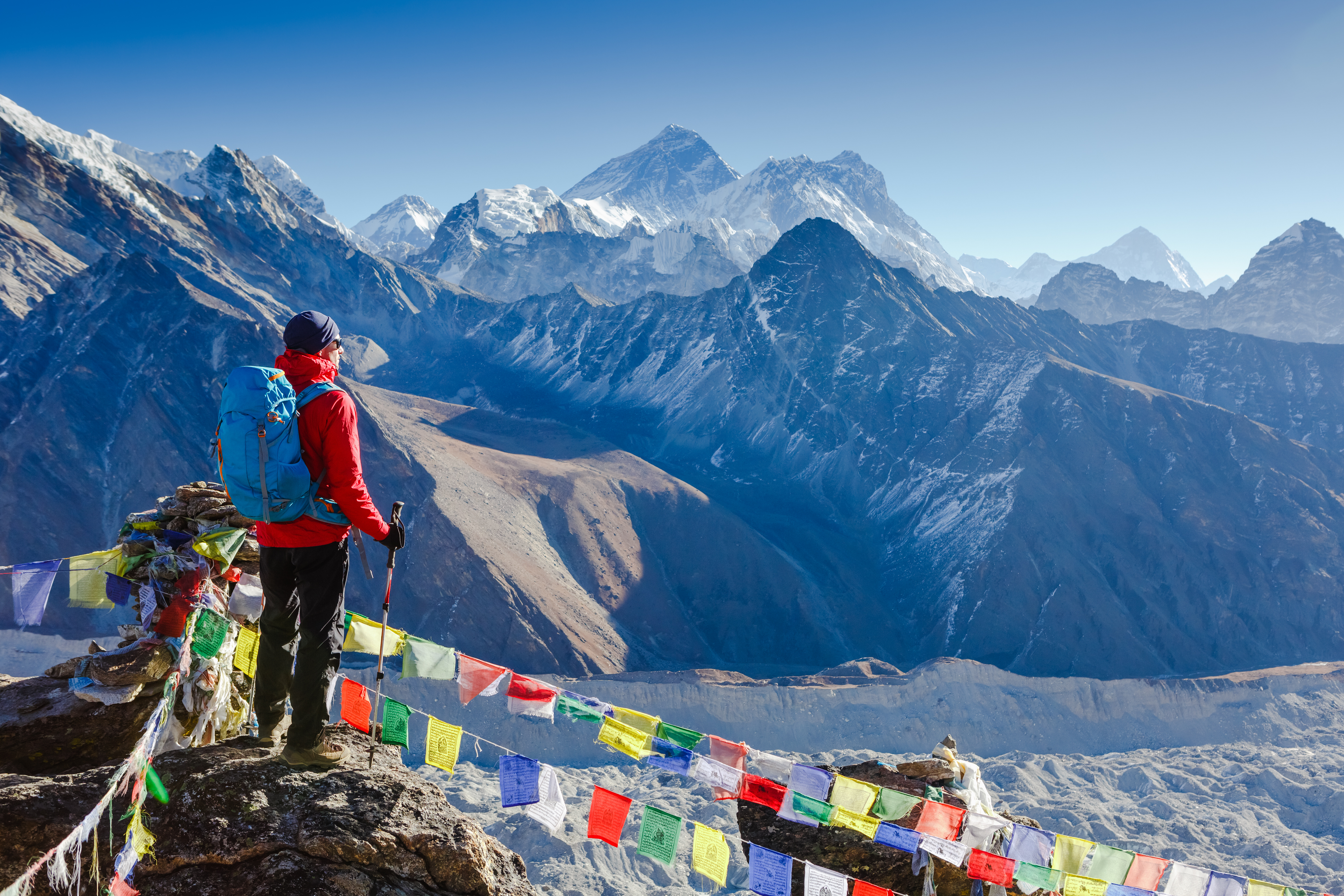 Active hiker hiking, enjoying the view, looking at Himalaya mountains landscape 