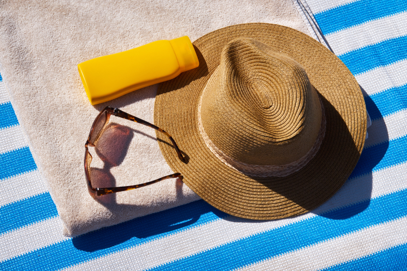 sunscreen, towel, hat, sun glasses