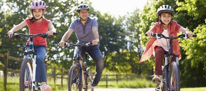 A man and his two children biking outdoor