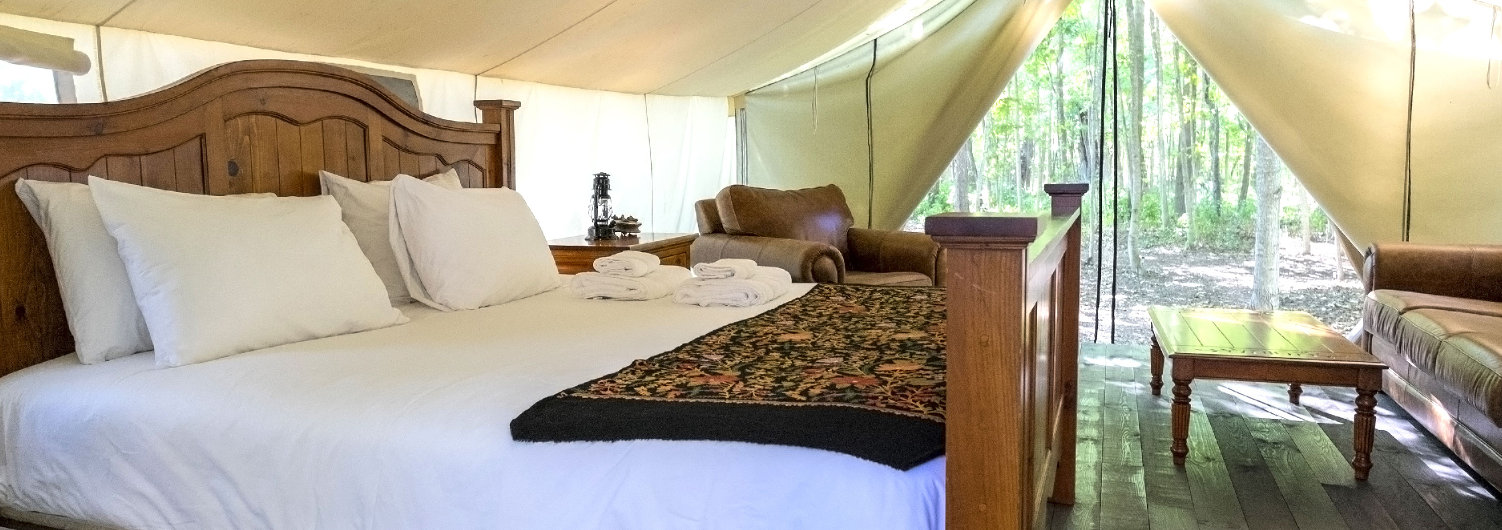 Luxurious furniture in a glamping tent in the woods