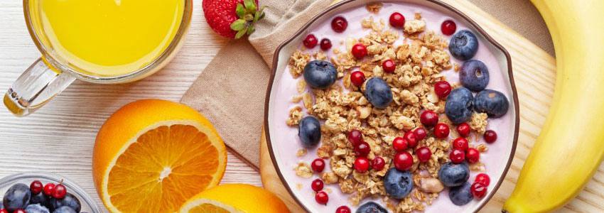 A bowl of cereal surrounded by other healthy food