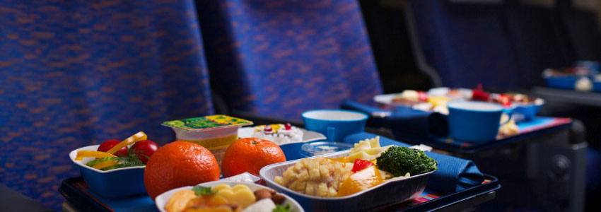 Airplane seats with full meals on the seat trays