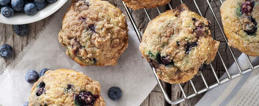Blueberry muffins with berries and cooling rack