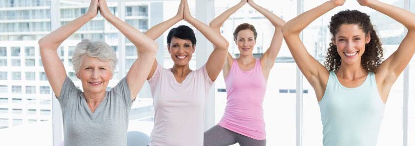A group of women doing the same yoga pose together