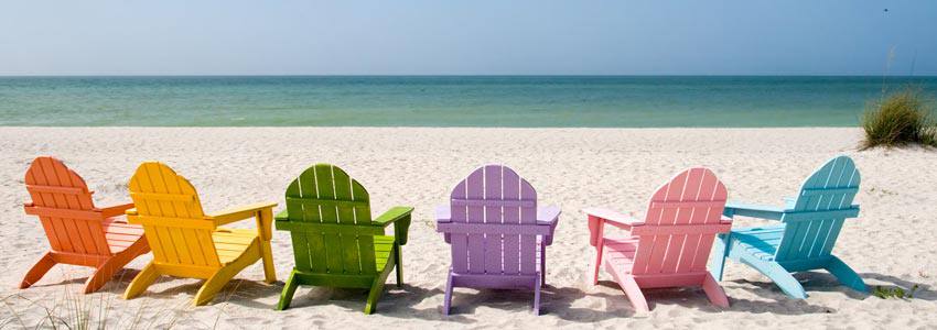 Six beach chairs with different colors on the beach