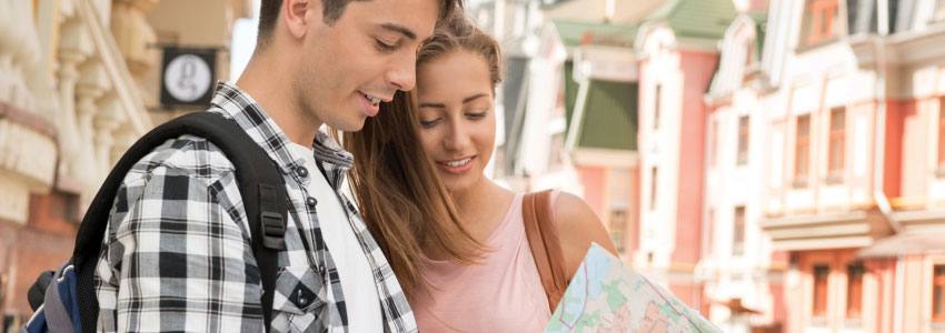 A traveling couple looks at a map